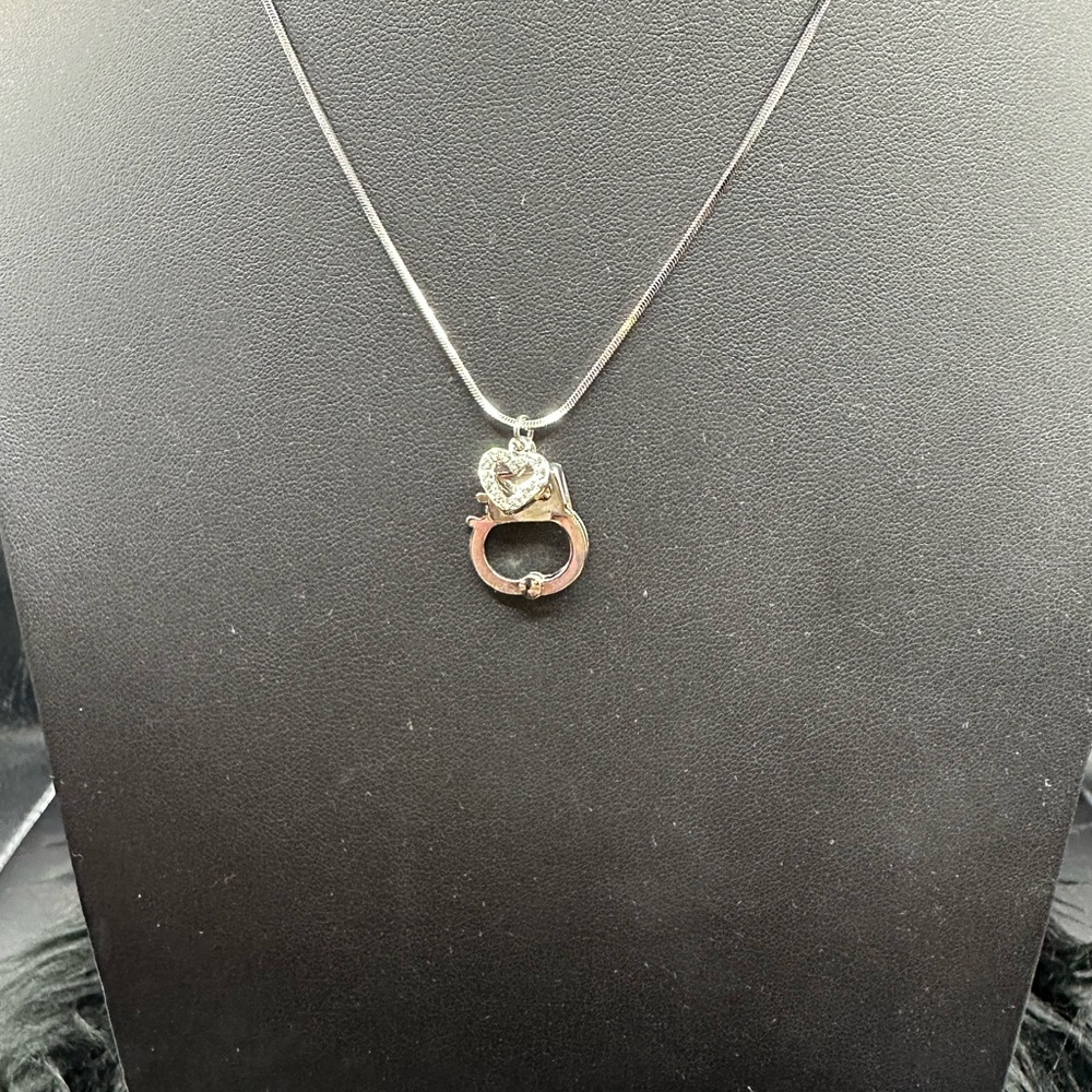 Handcuff - plain silver/heart - clear crystals pendant on a silver chain.